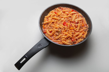 Cooked pasta in a pan white background