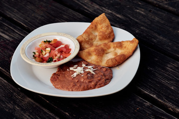 Belizean Fry Jacks on a plate with beans and ceviche