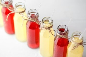 Delicious citrus and pomegranate lemonade in glass bottles. Concept of drinks, summer, bar, rest, healthy food.