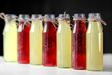 Fototapeta na wymiar Refreshing citrus and pomegranate lemonade in glass bottles. Concept of drinks, summer, bar, rest, healthy food.