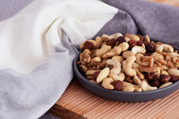 nuts in a bowl on a wooden board