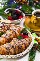 Obraz na płótnie Canvas Chocolate Croissants for Breakfast with Christmas Theme Background. Selective focus.