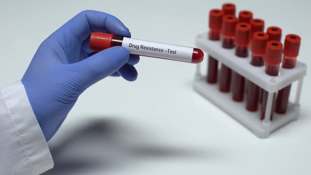 Drug resistance, doctor shows blood sample in tube, lab research, health checkup
