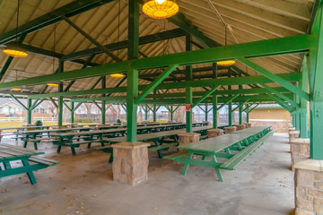 Fototapeta na wymiar Pavilion with long picnic tables and benches