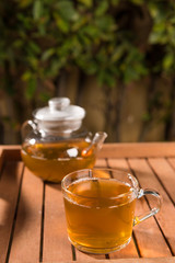 Composition with green tea on wooden table outdoors. Weight loss concept, nature background