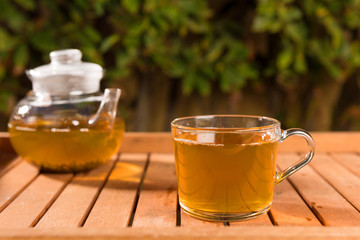 Composition with green tea on wooden table outdoors. Weight loss concept, nature background