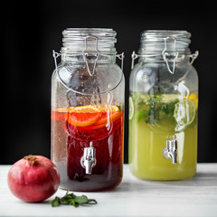 Fototapeta na wymiar Refreshments lemonade with lime, lemon, orange and pomegranate. Concept of drinks, summer, bar, rest, healthy food..