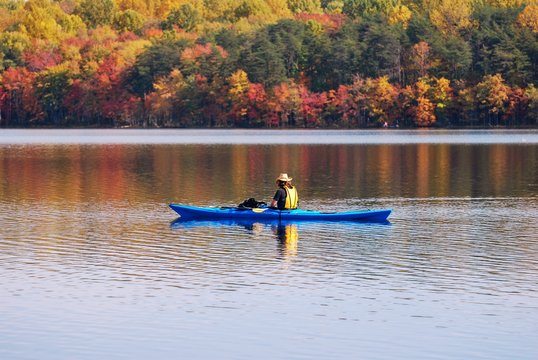 Kayaking in Lake with reflection of fall leaves.  