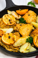 Chicken Thighs Roasted with Meyer Lemon and Potatoes. Selective focus.