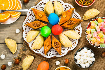 Novruz Ramadan in Azerbaijan. Colored Eggs, Wheat Springs for Easter and Traditional Sweets. Selective focus.