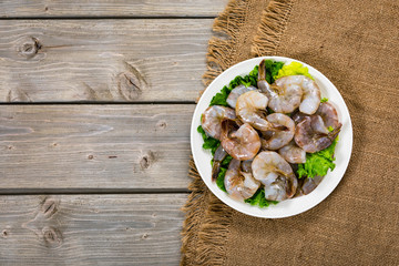 Large Raw Shrimp on Wooden Background. Selective focus.