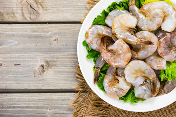 Large Raw Shrimp on Wooden Background. Selective focus.