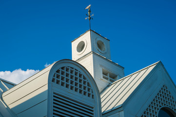 Scenic close-up view of traditional wooden seaside architecture with a seagull sitting atop a...