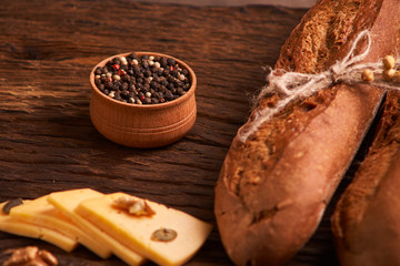 Peppercorns in a wooden bowl on table with food rustic style. Homemade food
