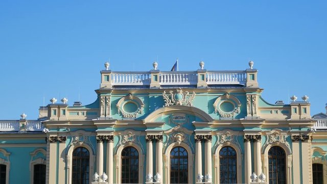 Ukrainian flag with trident waving on top of Mariyinsky Palace official ceremonial residence of the President of Ukraine in Kiev