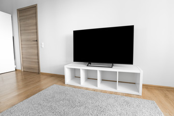 Lcd tv on white shef at new room interior