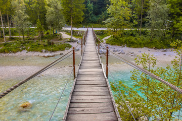 Swingbridge over blue Soca river near Bovec