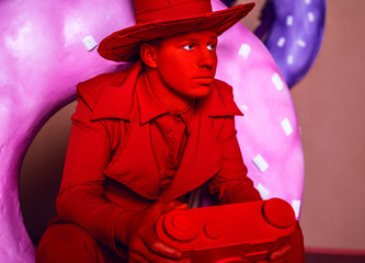 Stylized fantasy red photographer in scenic make-up with camera.