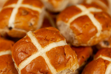 Close up of a pile of hot cross buns
