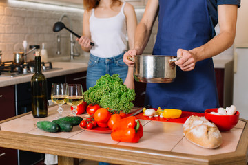 Couple cooking together in the kitchen at home
