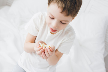 Boy eating popcorn sitting in bed