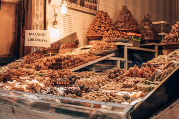 Delicious moroccan sweets, in a shop in the middle of the famous souks of Marrakech. - obrazy, fototapety, plakaty