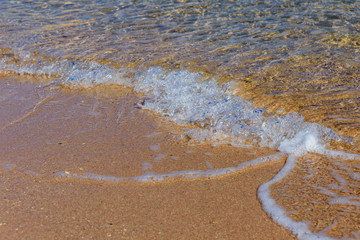 Closeup of the sand on beach and Red sea water
