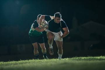 Rugby player running with ball for making score - Powered by Adobe