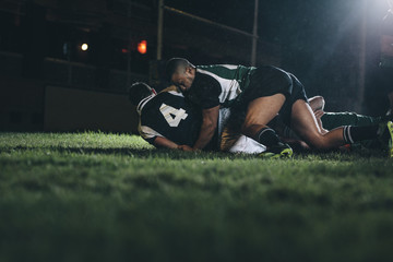 Rugby players fight for the ball