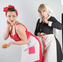 two cute girlfriends dressed up for a costume cosplay party. one girl is dressed as a housewife in...