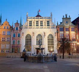 Fototapeta na wymiar Fountain of the Neptune in old town of Gdansk, Poland. Long Lane architecture. Artus Yard.