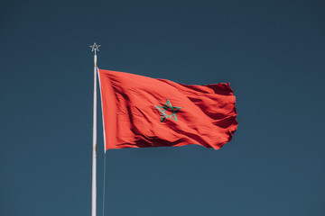 Naklejka na ściany i meble Flag of Morocco waving in a strong wind