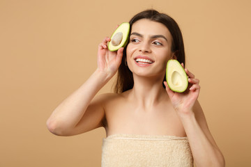 Close up brunette half naked woman 20s with perfect skin nude make up hold avocado isolated on...
