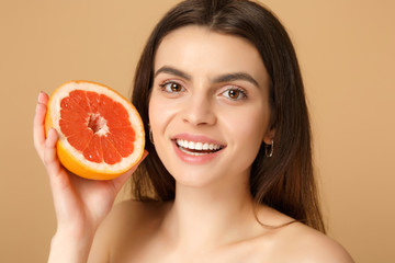 Close up beauty half naked woman 20s with perfect skin nude make up hold grapefruit isolated on...