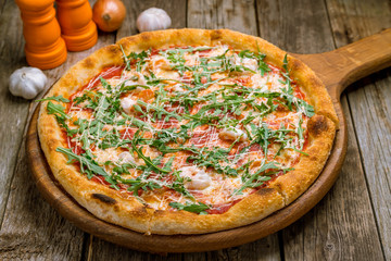 Pizza with arugula and shrimp