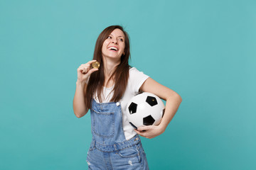 Laughing happy young woman football fan support favorite team with soccer ball, bitcoin future...