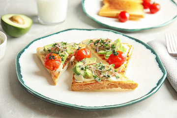 Tasty toasts with avocado, sprouts and chia seeds on plate