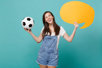 Pensive woman football fan cheer up support team with soccer ball, empty blank yellow Say cloud, speech bubble isolated on blue turquoise background. People emotions, sport family leisure concept.