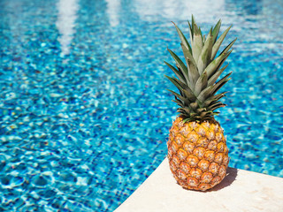 Pineapple near swimming pool at poolside