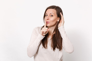 Pretty young woman say hush be quiet with finger on lips shhh gesture, eavesdrop with hearing...