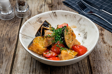 fried eggplant in sweet sour sauce with tomatoes