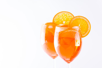 Cocktail aperol spritz on white background. Summer alcoholic cocktail with orange slices. Italian cocktail aperol spritz on white. Isolated