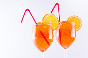 Cocktail aperol spritz on white background. Summer alcoholic cocktail with orange slices. Italian cocktail aperol spritz on white. Isolated