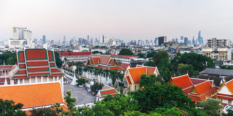 Panorama view of Bangkok from Golden Mountain at sunset cloudy sky, Thailand. Traditional architecture of Bangkok