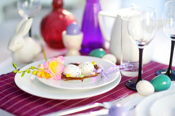 Beautiful table setting with crockery and flowers for Easter celebration.