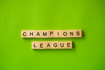 The word CHAMPIONS LEAGUE shot flat lay on a green isolated background