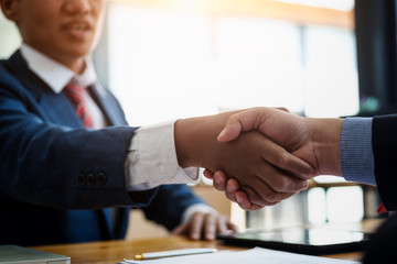 Business real estate broker and customer shaking hands after signing a contract housing estate in office. contract and agreement concept.