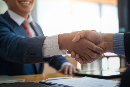 Business real estate broker and customer shaking hands after signing a contract housing estate in office. contract and agreement concept.