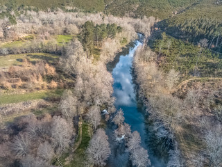 Aerial view of drone, artificial lake and dense forest on the banks