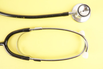 Medical Concept with stethoscope ,syringe  isolated on yellow background. Copy Space